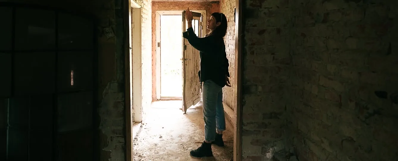 Aleksandra in the raw brick hallway of the Solnica house