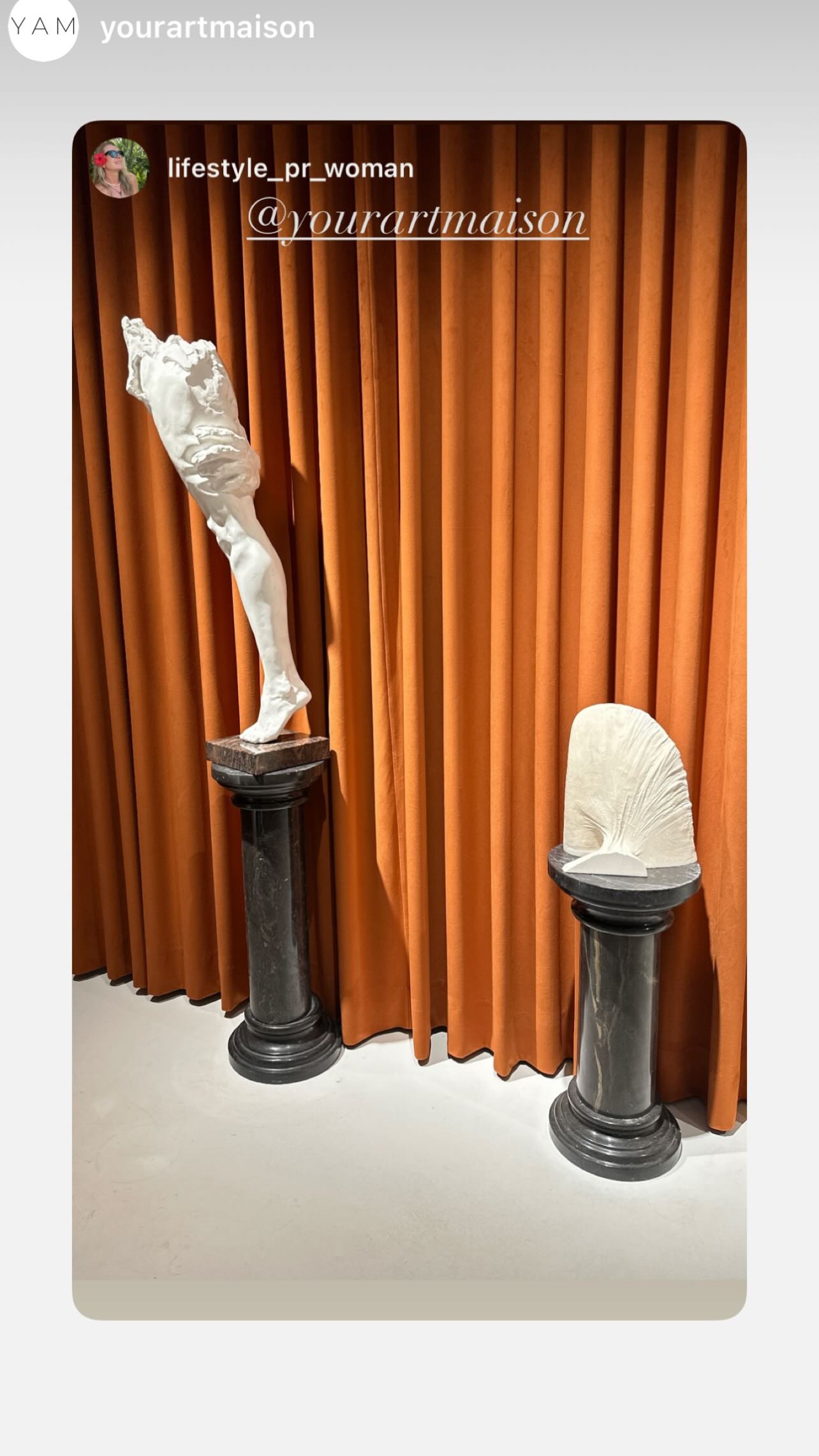 Sculpture against an amber curtain